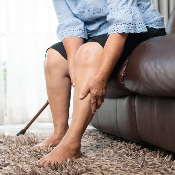 Leg pain of senior woman at home, healthcare problem of senior concept